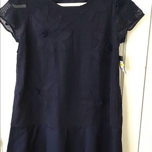 Navy dress with floral embellishments.